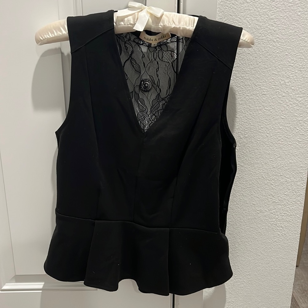 Robbi & Nikki peplum top. Lace detail on back.